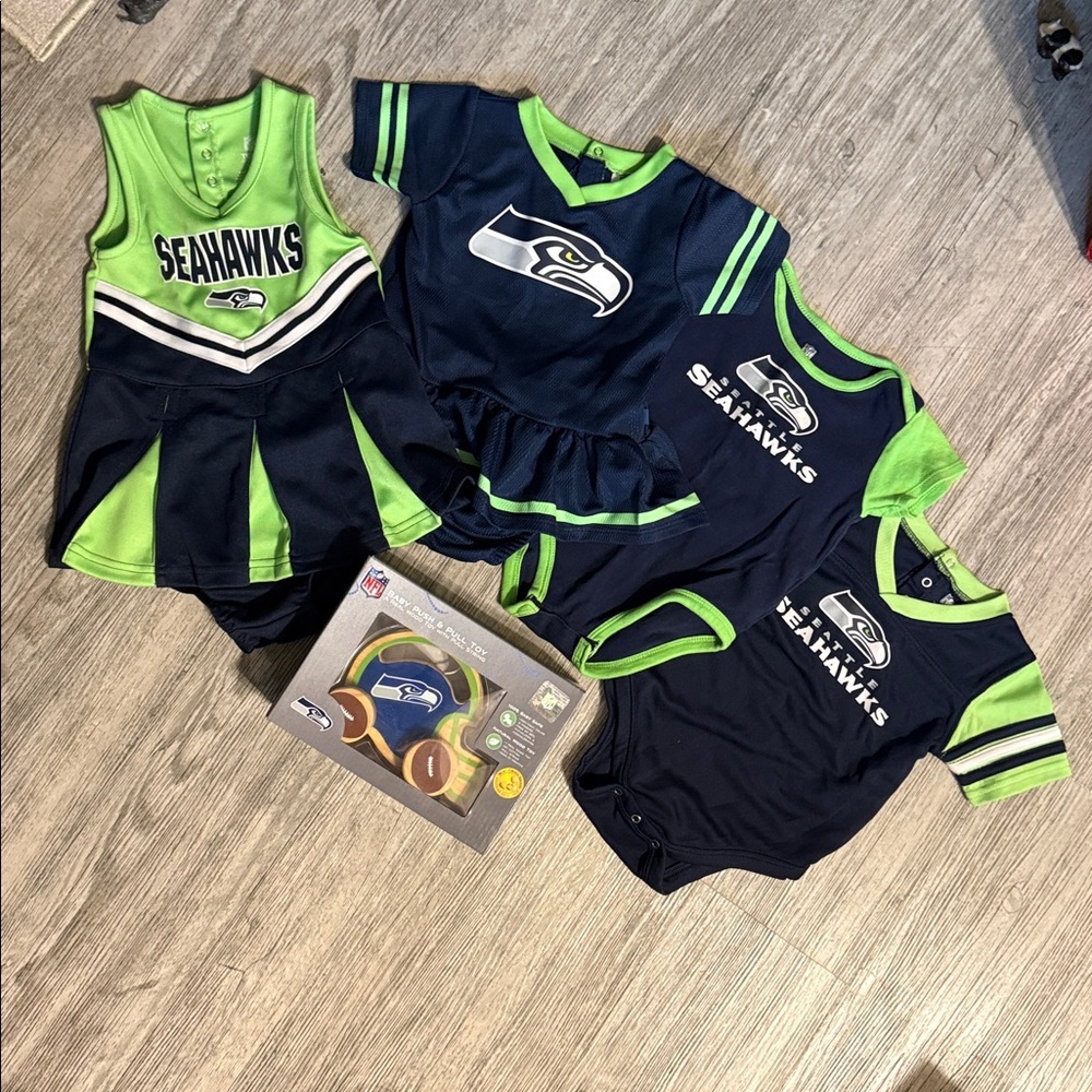 4 Seahawk baby cheer sets and onesies & baby push & pull toy!